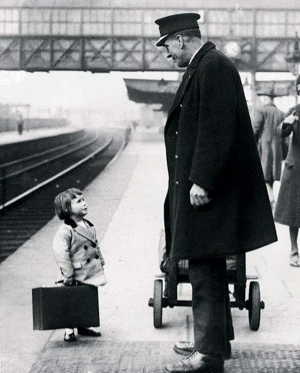A young passenger asks a station attendant for directions. Bristol Railway Station, England, 1936 Photo George W. Hales