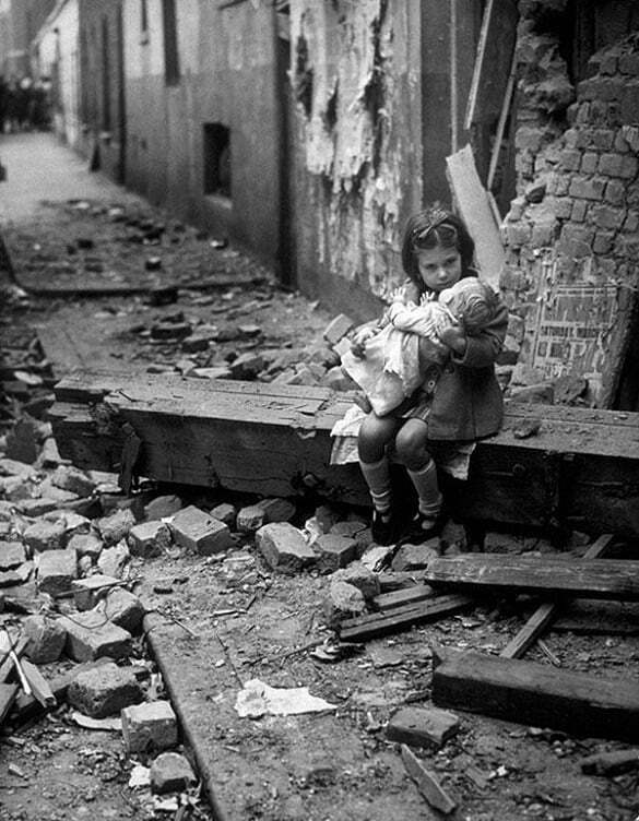 17-Little-girl-with-her-doll-sitting-in-the-ruins-of-her-bombed-home-London-1940