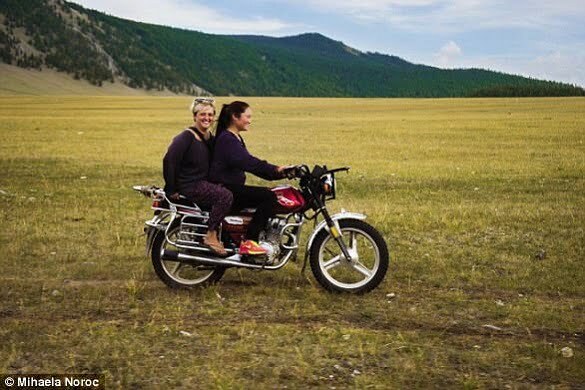 Photographer Mihaela on the back of a motorbike during her travels in Asia