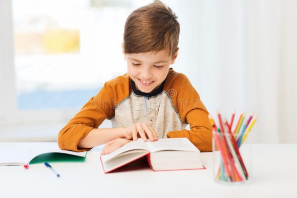 smiling-student-boy-reading-book-home-education-childhood-people-homework-school-concept-happy-textbook-65817245